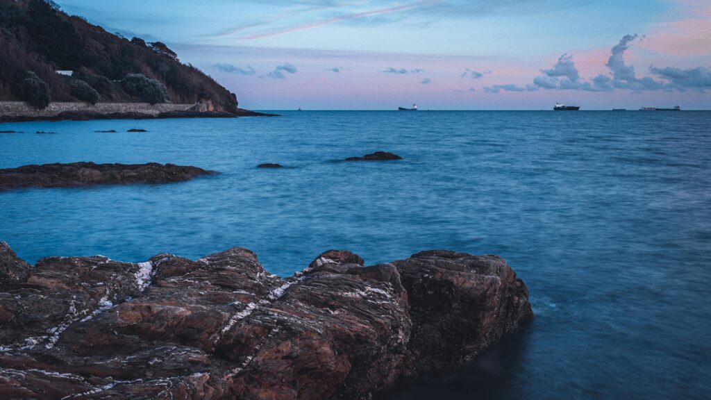 Falmouth harbour coastline with cargo vessels, supporting A&P Falmouth marine infrastructure project.